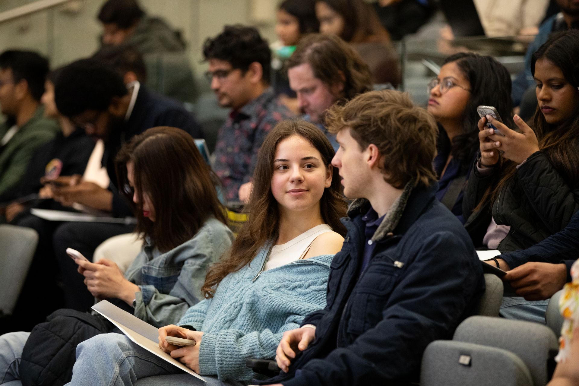 Two students chatting at an event.